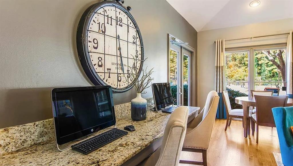 3780 Towne Crossing, Unit 511E Kennesaw, GA 30144 - Photo 8 of 12 a view of workspace with wooden floor outdoor seating and kitchen view