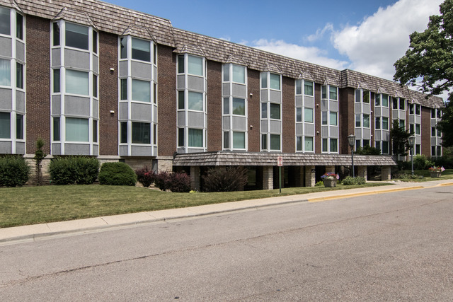 a front view of a building with a yard