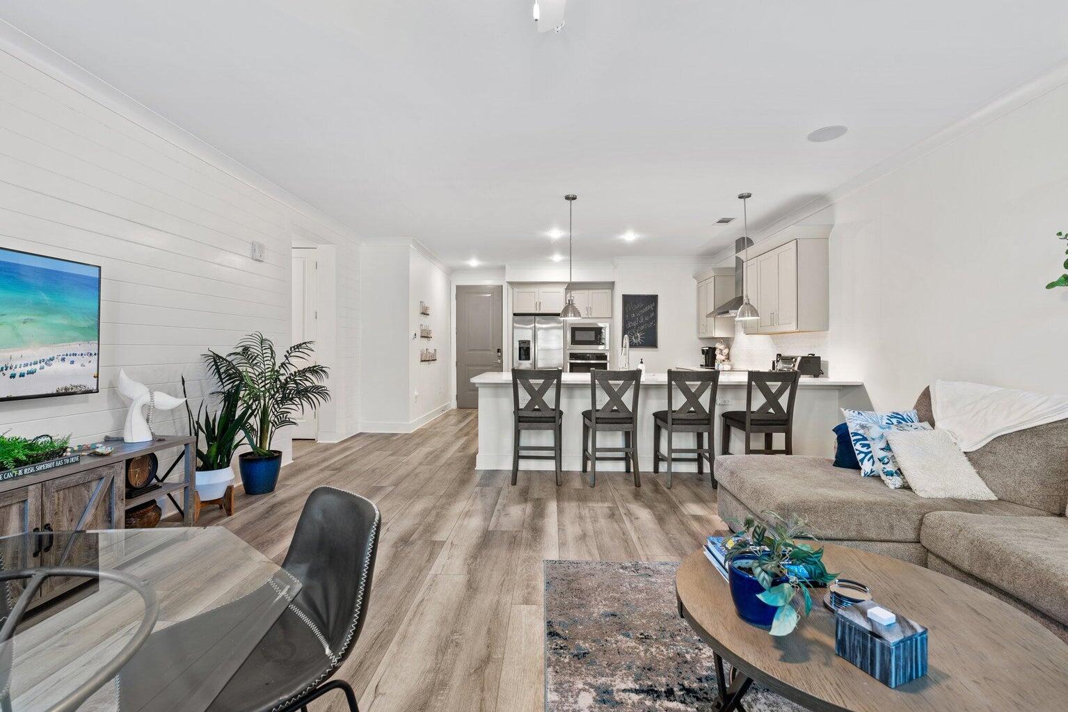 179 South County Highway 393, Unit 313 Santa Rosa Beach, FL 32459 - Photo 11 of 37 a living room with furniture kitchen view and a large window