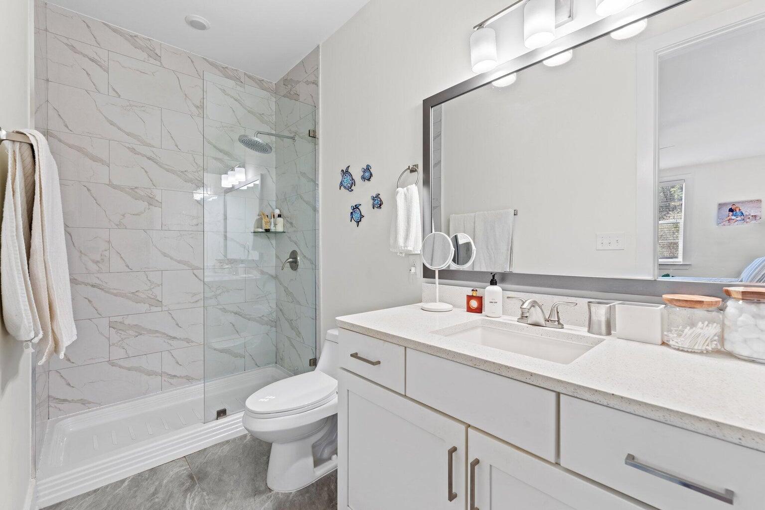 179 South County Highway 393, Unit 313 Santa Rosa Beach, FL 32459 - Photo 16 of 37 a bathroom with a sink a toilet and shower