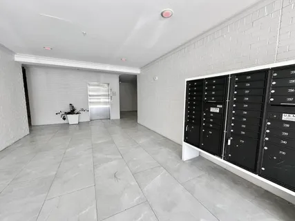 a large white kitchen with stainless steel appliances and white cabinets