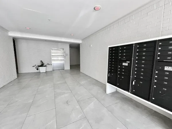 a large white kitchen with stainless steel appliances and white cabinets