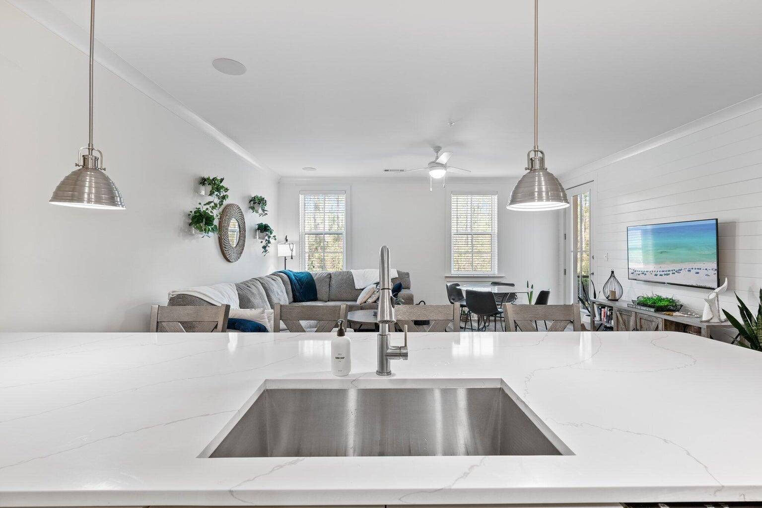 179 South County Highway 393, Unit 313 Santa Rosa Beach, FL 32459 - Photo 8 of 37 a view of living room with kitchen island furniture and a chandelier
