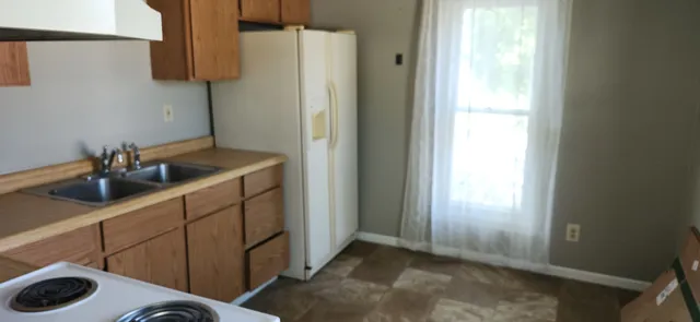 a kitchen with a sink and a refrigerator