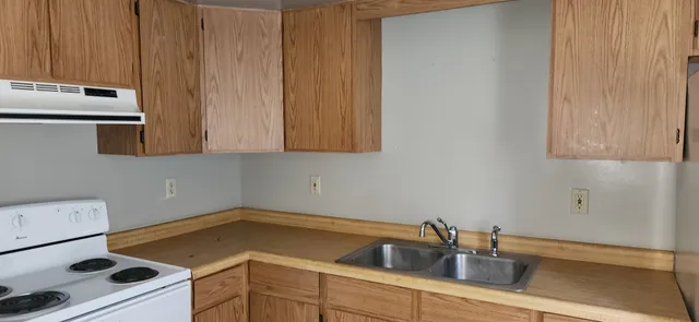 a kitchen with a sink and cabinets