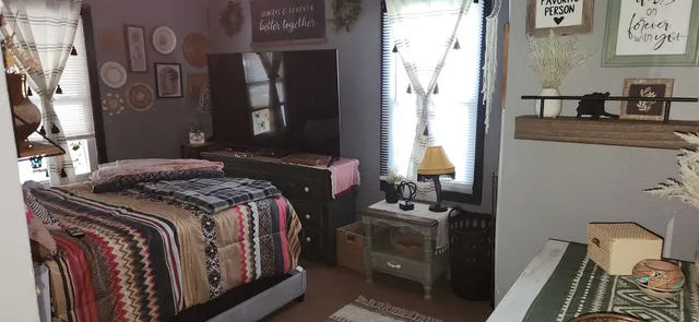 a bedroom with a bed and a window