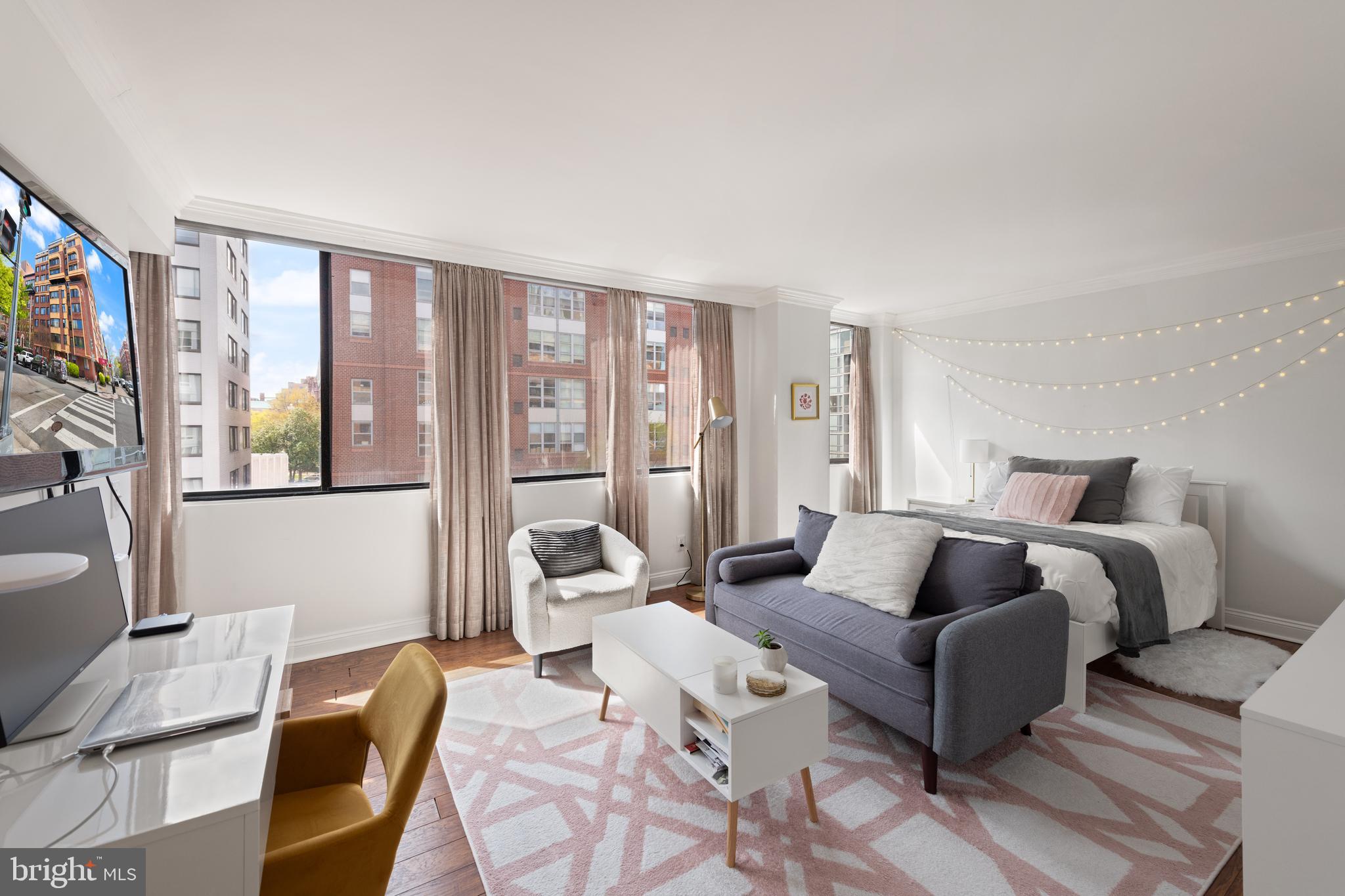 a bedroom with a bed and glass window