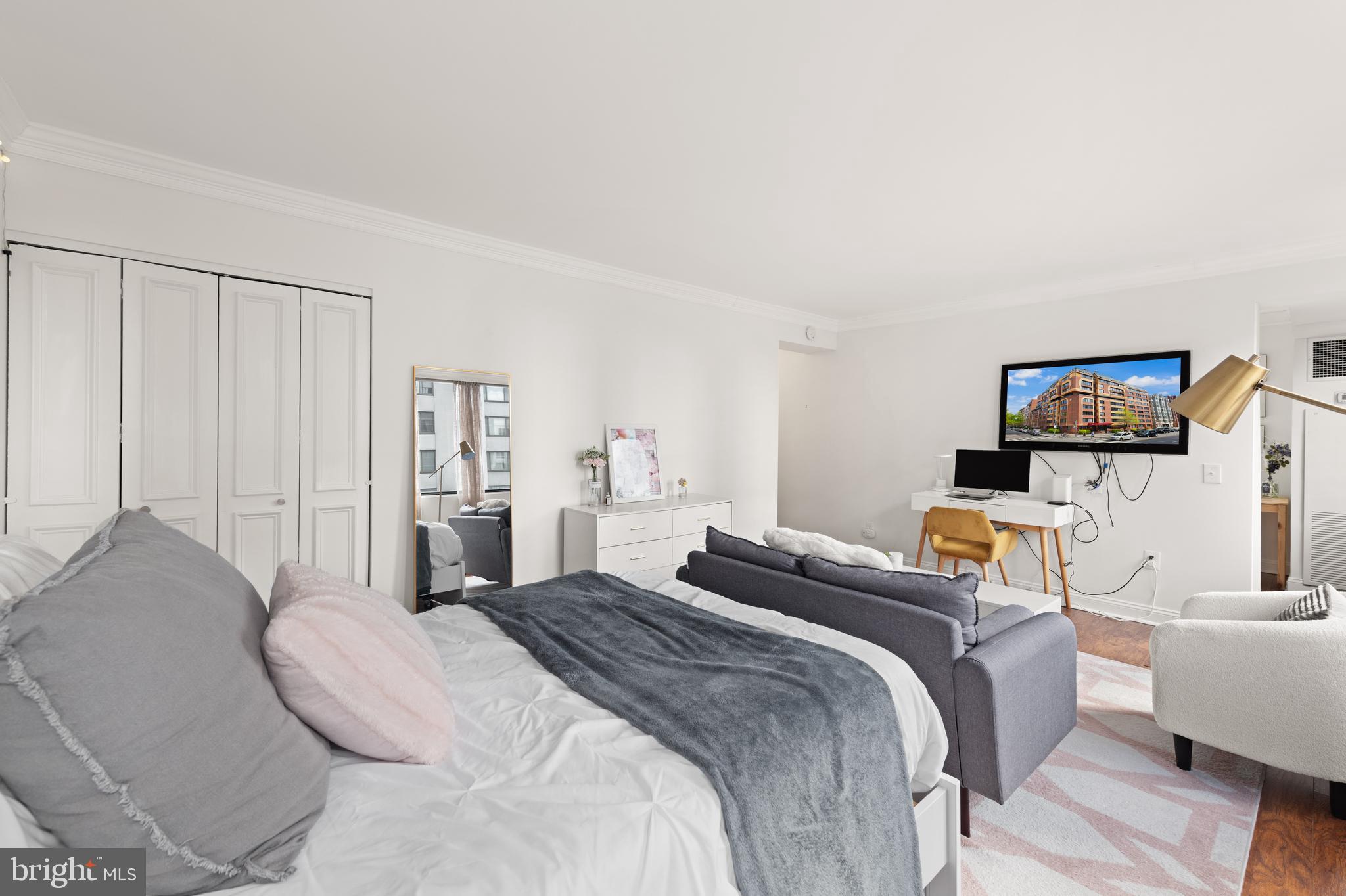 1245 13th Street Northwest, Unit 516 Washington, DC 20005 - Photo 11 of 25 a bedroom with a bed and a flat screen tv