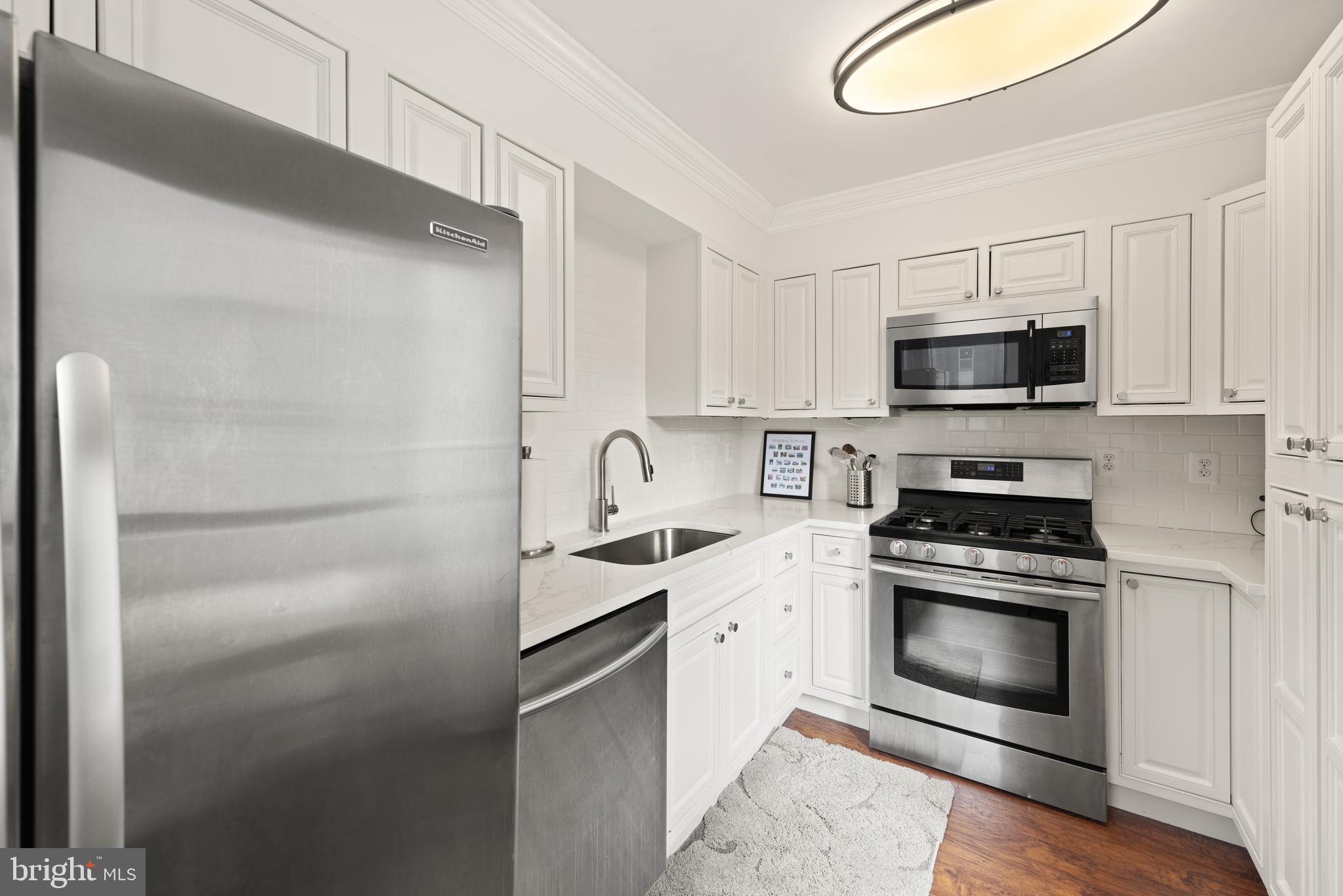 1245 13th Street Northwest, Unit 516 Washington, DC 20005 - Photo 14 of 25 a kitchen with a sink stove and microwave