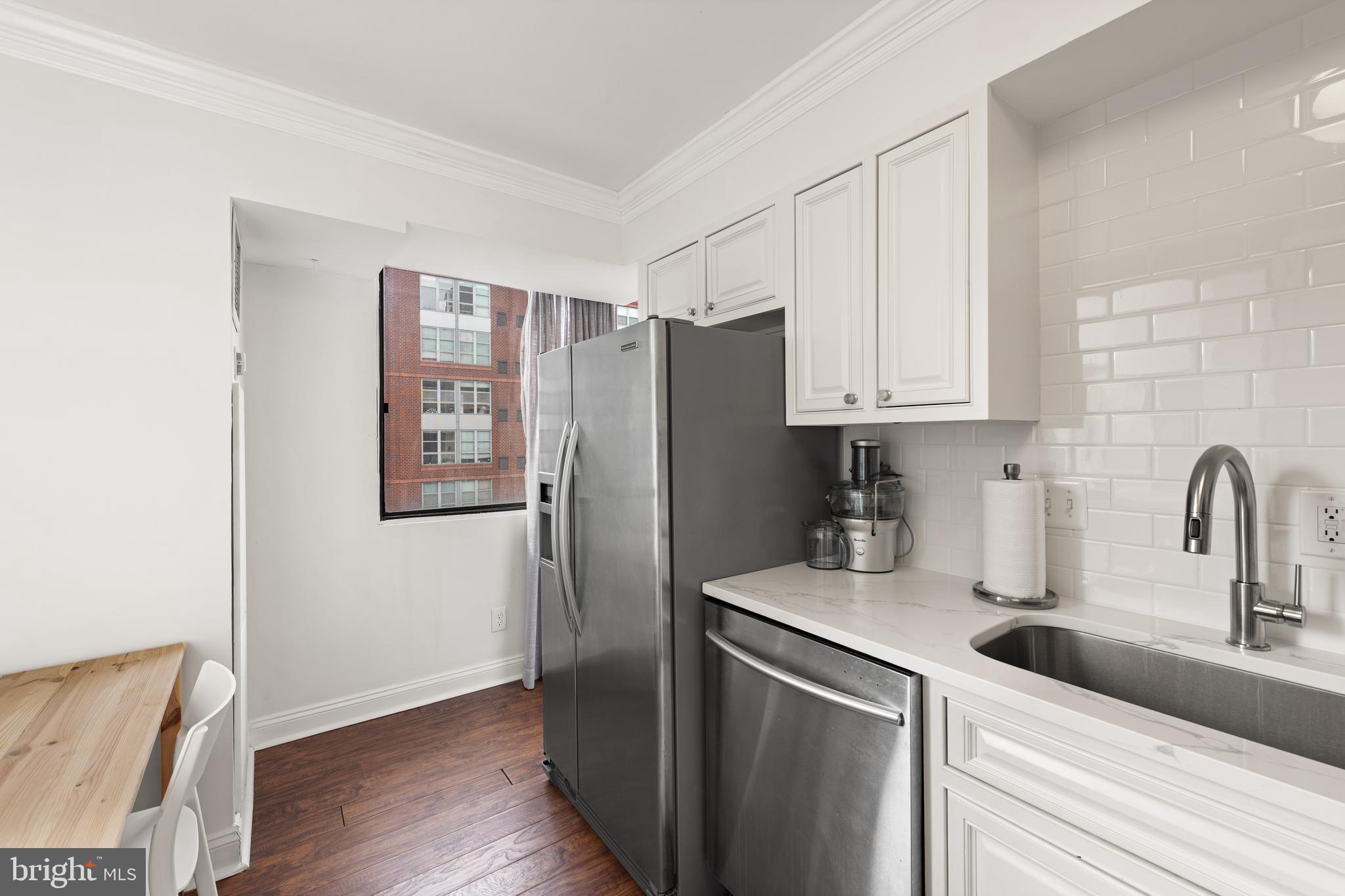 1245 13th Street Northwest, Unit 516 Washington, DC 20005 - Photo 16 of 25 a kitchen with stainless steel appliances granite countertop a refrigerator sink and stove