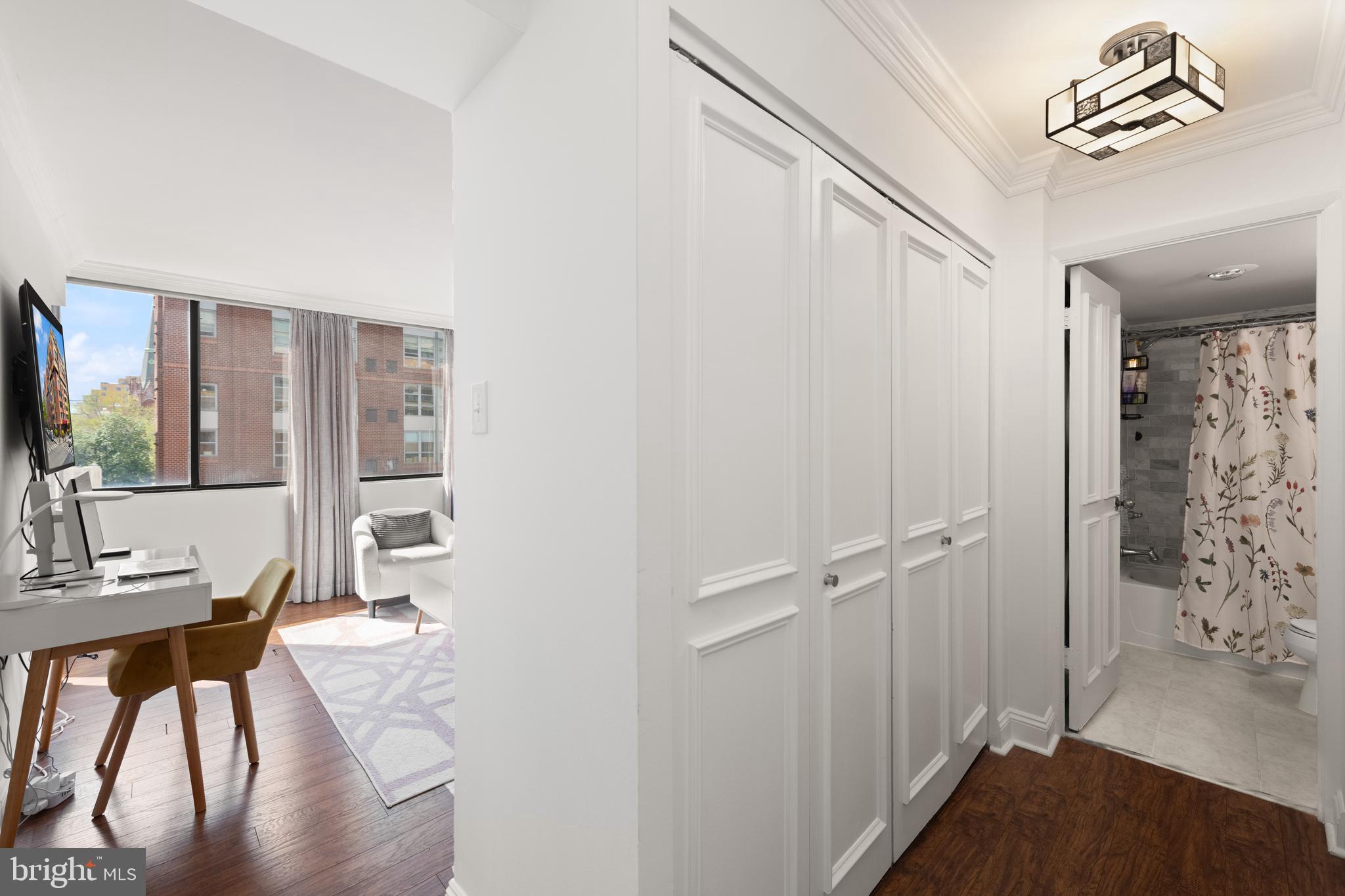 1245 13th Street Northwest, Unit 516 Washington, DC 20005 - Photo 21 of 25 a bedroom with a bed and a table in it