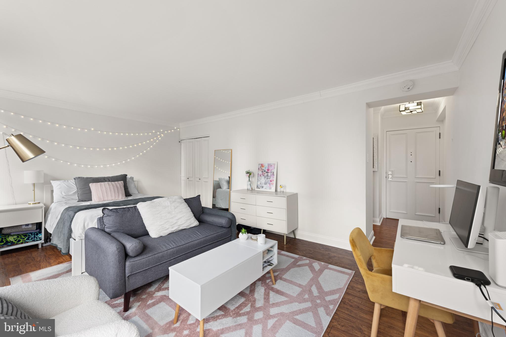 1245 13th Street Northwest, Unit 516 Washington, DC 20005 - Photo 10 of 25 a living room with furniture a rug and a table