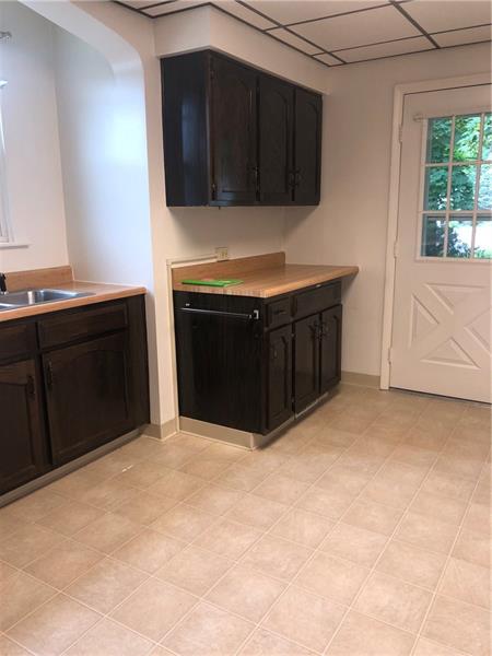 22 Hemlock Street Ellsworth, PA 15331 - Photo 4 of 23 Another part of the spacious kitchen, there is an abundance of cabinets and counters! You do have access to the outside from this area also!