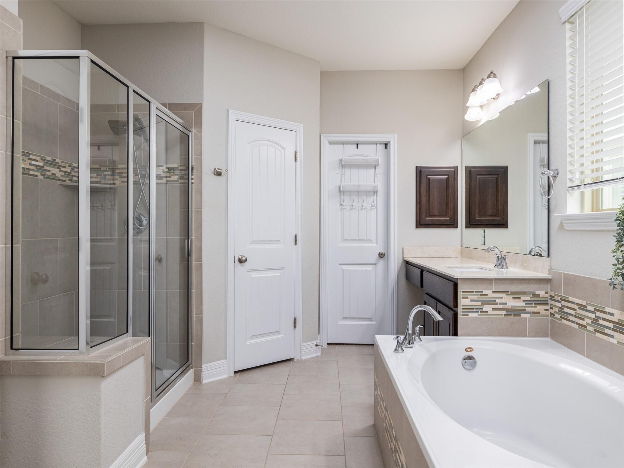 717 Blue Agave Lane Georgetown, TX 78626 - Photo 13 of 28 a bathroom with a tub a sink a mirror and a shower
