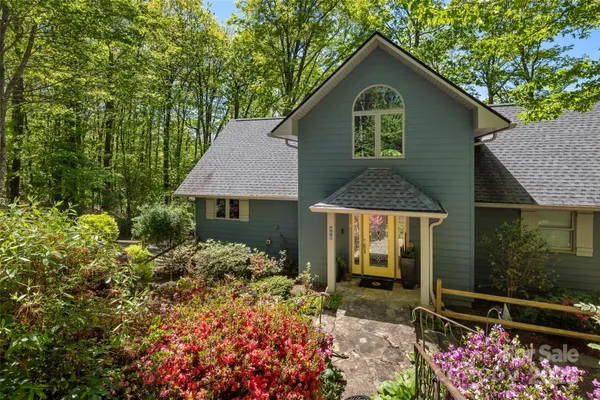 a living room with furniture a fireplace and a large window