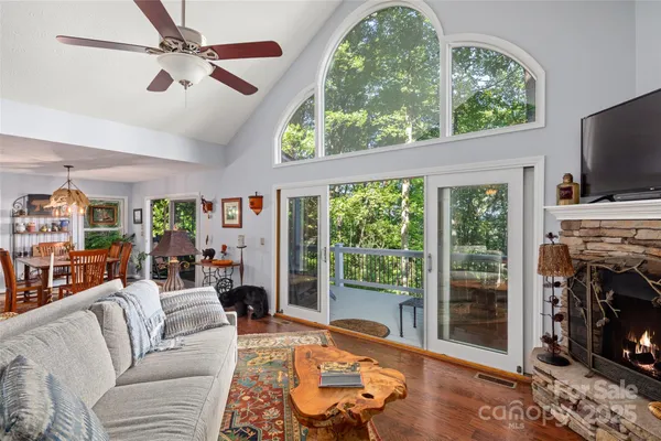 a living room with furniture a bookshelf and a fireplace