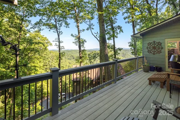 a view of balcony with wooden floor and fence