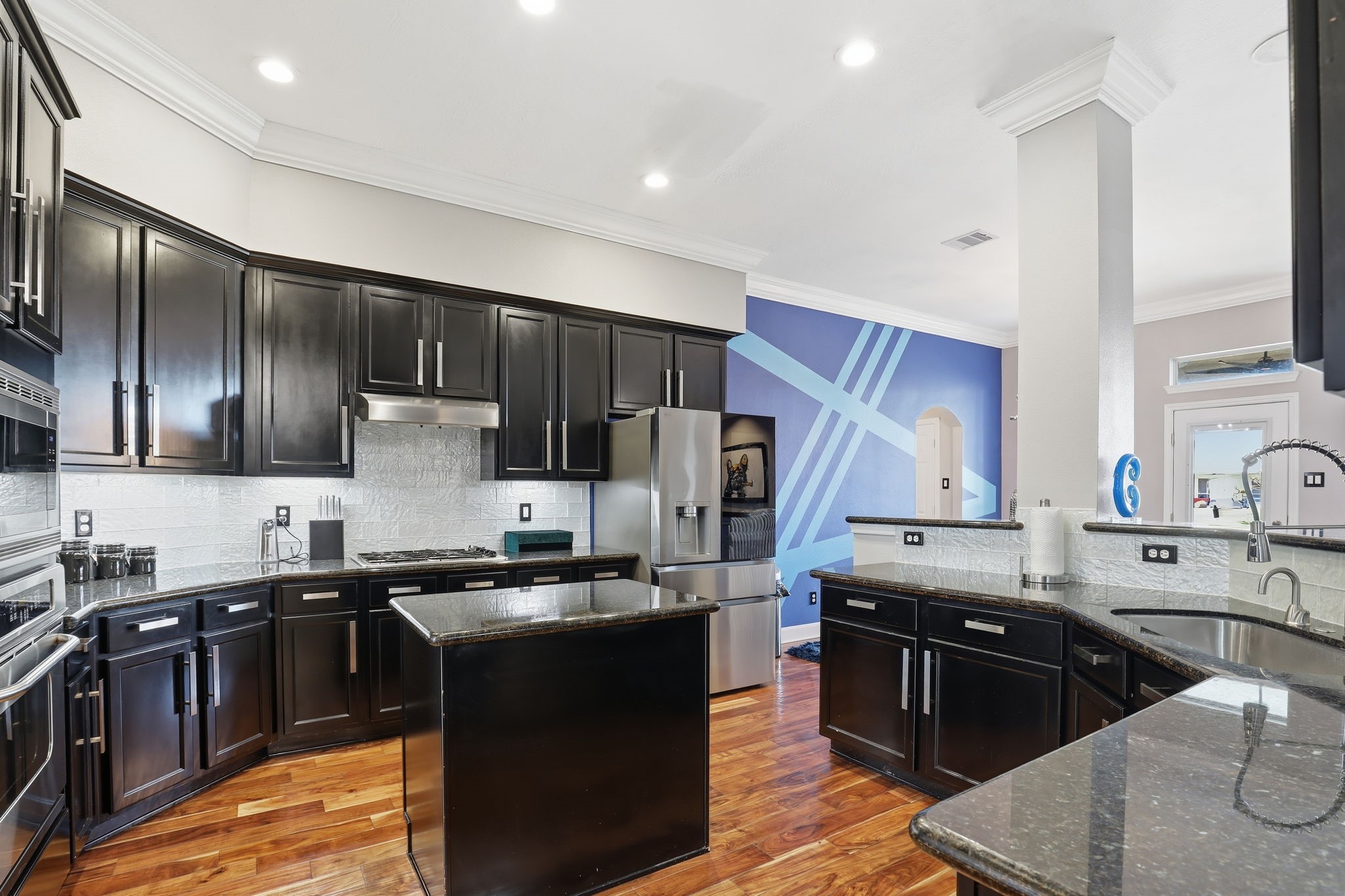 18014 Grotto Point Drive Cypress, TX 77429 - Photo 11 of 25 a kitchen with stainless steel appliances granite countertop a stove a sink a refrigerator and a microwave