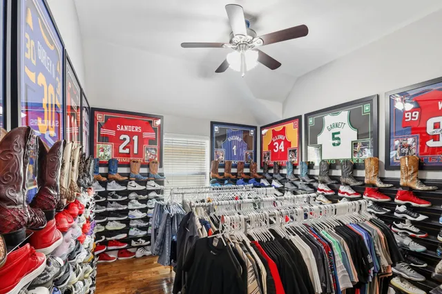 a living room with furniture and a painting on the wall