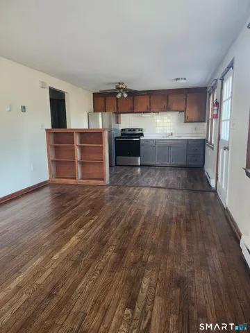 a kitchen with wooden floors and wooden cabinets
