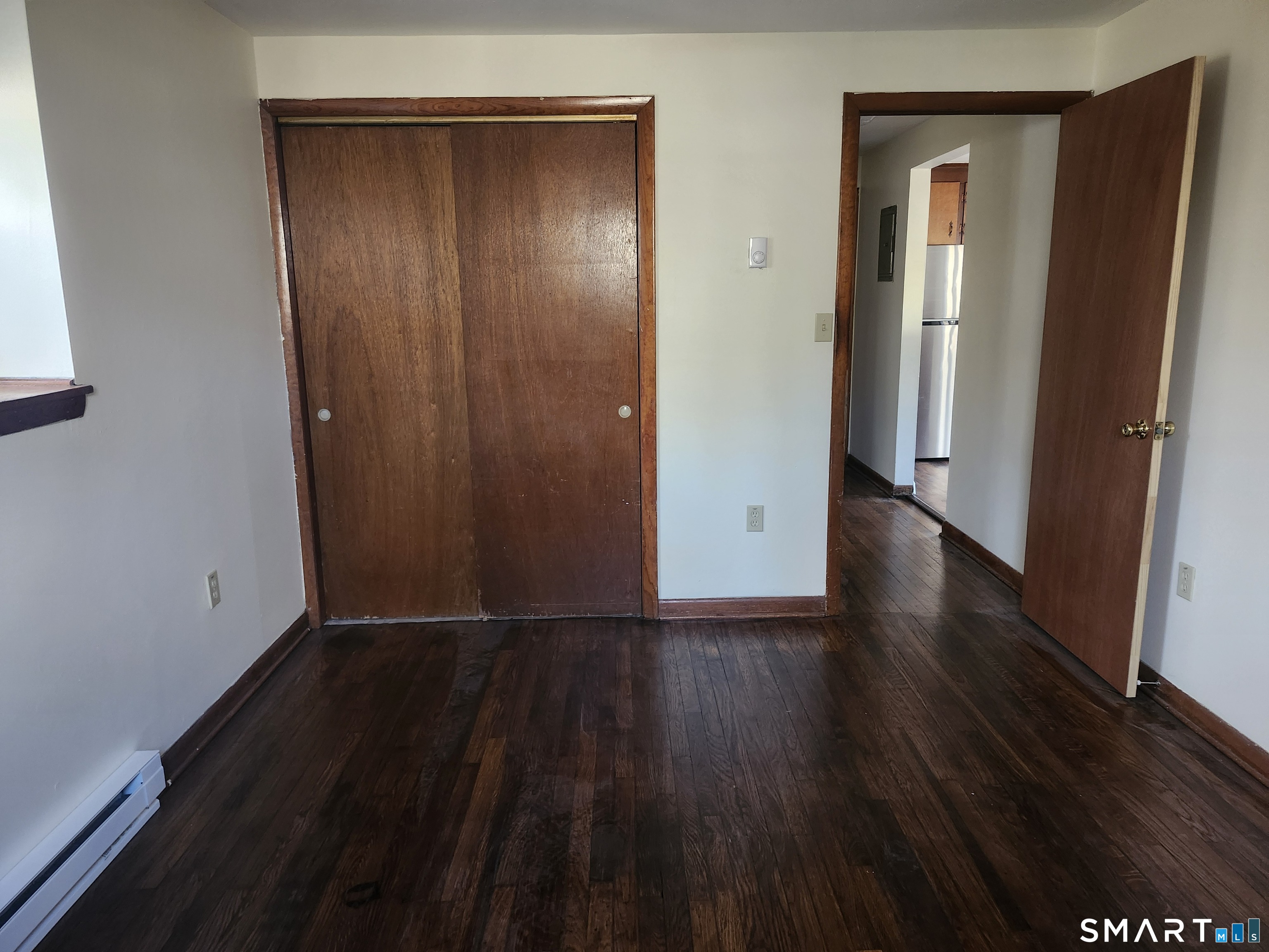 16 Polly Road, Unit A Lebanon, CT 06249 - Photo 4 of 9 an empty room with wooden floor and closet