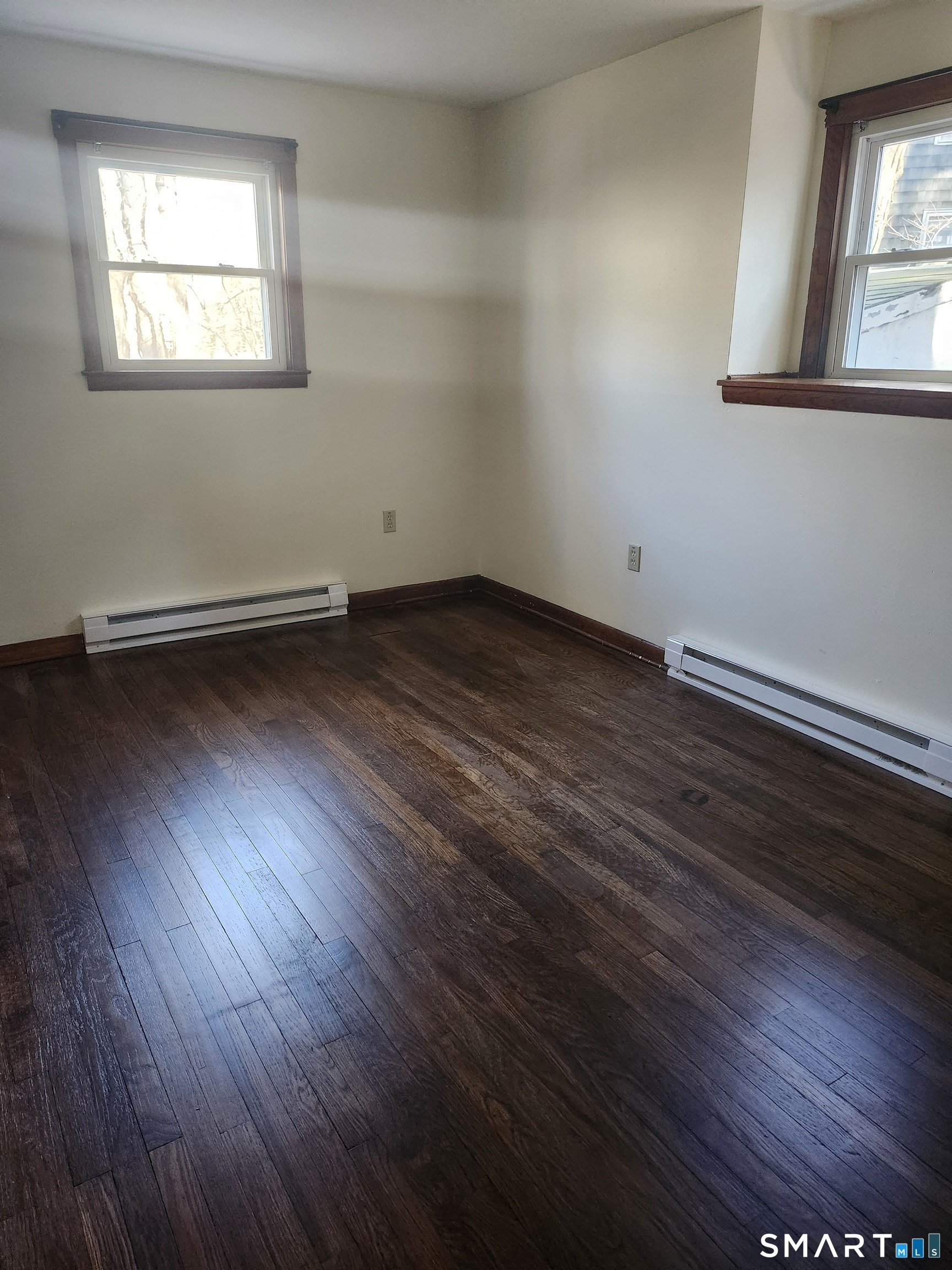 16 Polly Road, Unit A Lebanon, CT 06249 - Photo 6 of 9 an empty room with wooden floor and windows