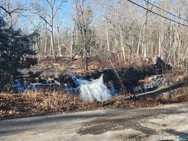 a view of a yard with wooden fence