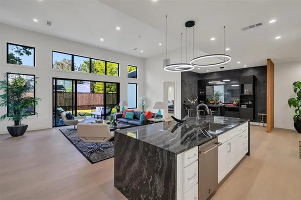 a kitchen with a stove cabinets and living room view