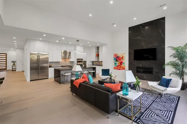 a living room with furniture kitchen and a flat screen tv