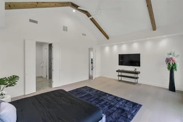 a bedroom with furniture and a flat screen tv