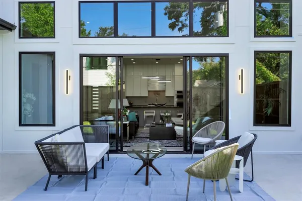 a view of backyard of house with seating space