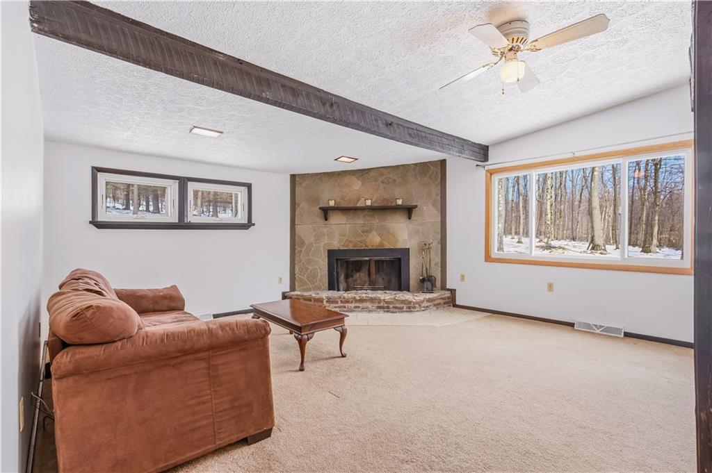 255 Evergreen Lane Acme, PA 15610 - Photo 11 of 27 a living room with furniture and a fireplace