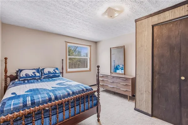 a bedroom with a bed and a table