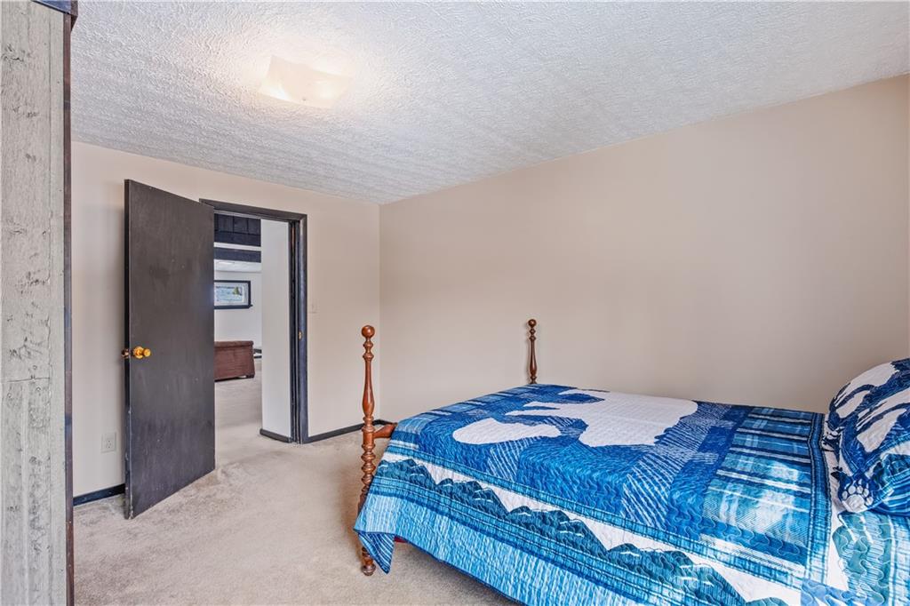 255 Evergreen Lane Acme, PA 15610 - Photo 15 of 27 a bedroom with a bed and a table