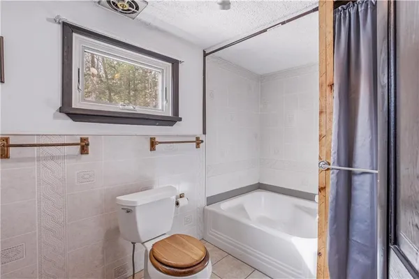 a bathroom with a sink toilet and mirror
