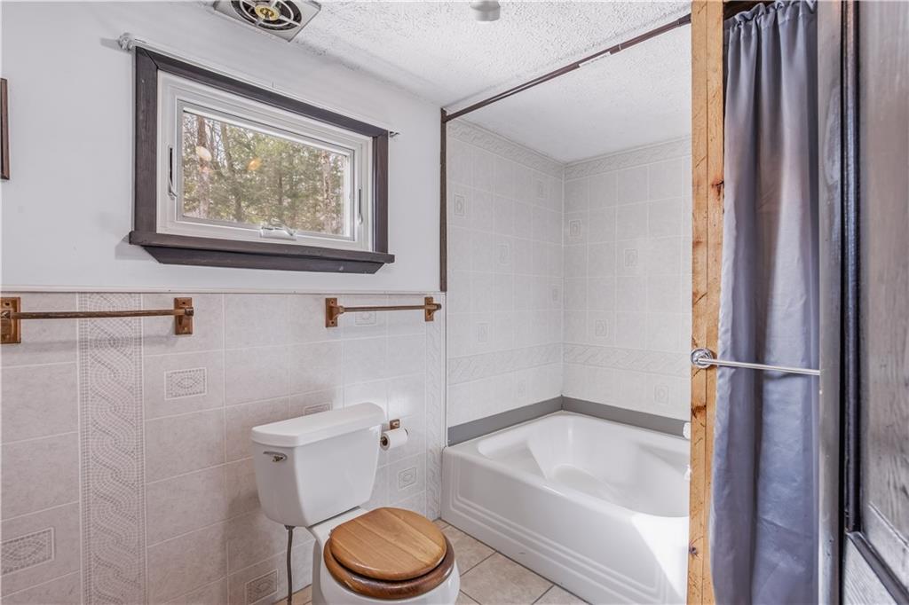 255 Evergreen Lane Acme, PA 15610 - Photo 16 of 27 a bathroom with a toilet and a bathtub