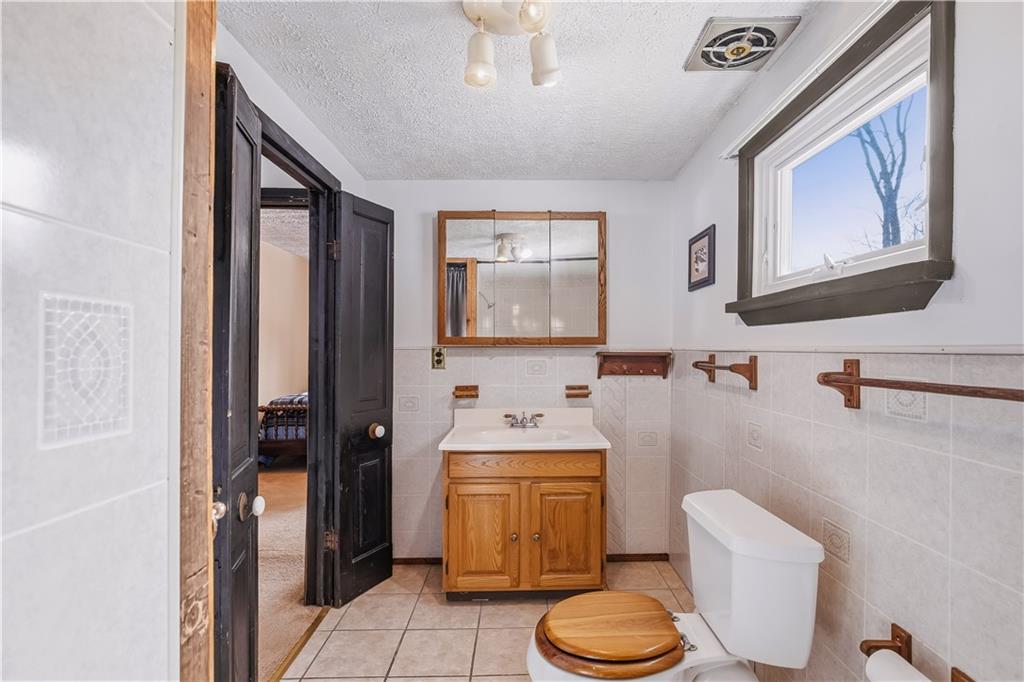 255 Evergreen Lane Acme, PA 15610 - Photo 17 of 27 a bathroom with a sink toilet and mirror