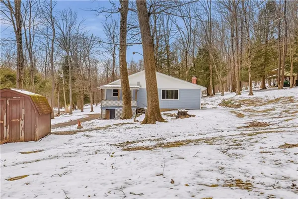 a view of a house with snow on the road