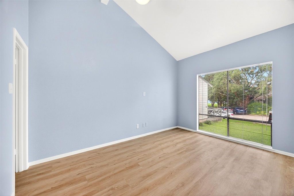 17 April Point Drive North Conroe, TX 77356 - Photo 29 of 42 wooden floor in an empty room with a window
