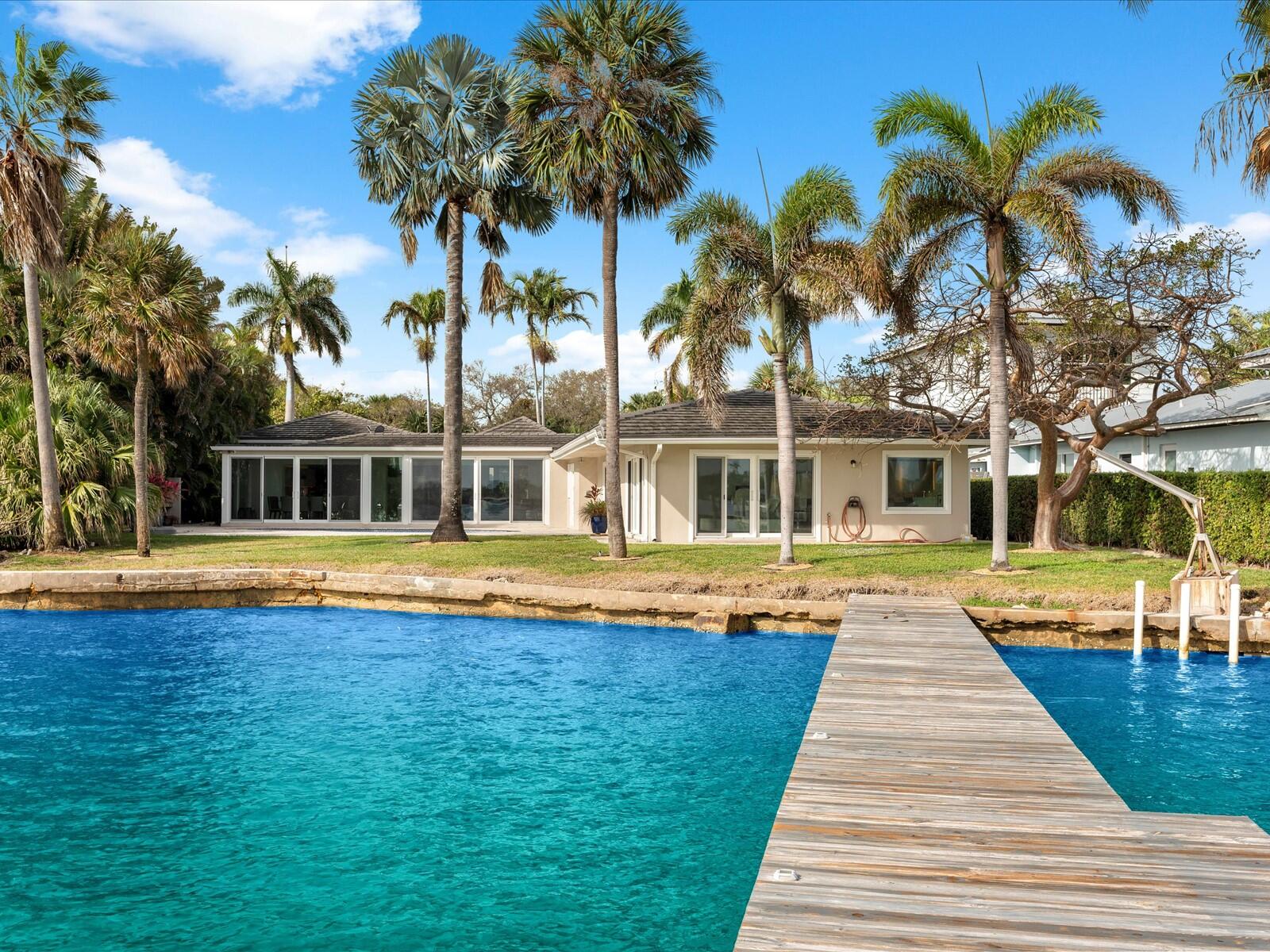 a view of swimming pool with palm trees