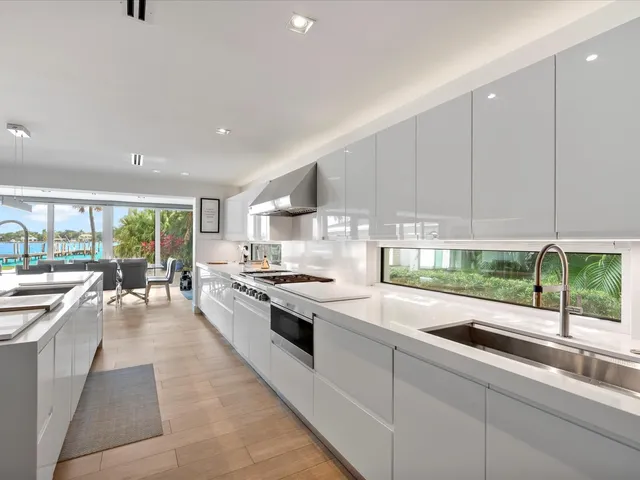 a kitchen with stainless steel appliances granite countertop a stove a sink and a refrigerator