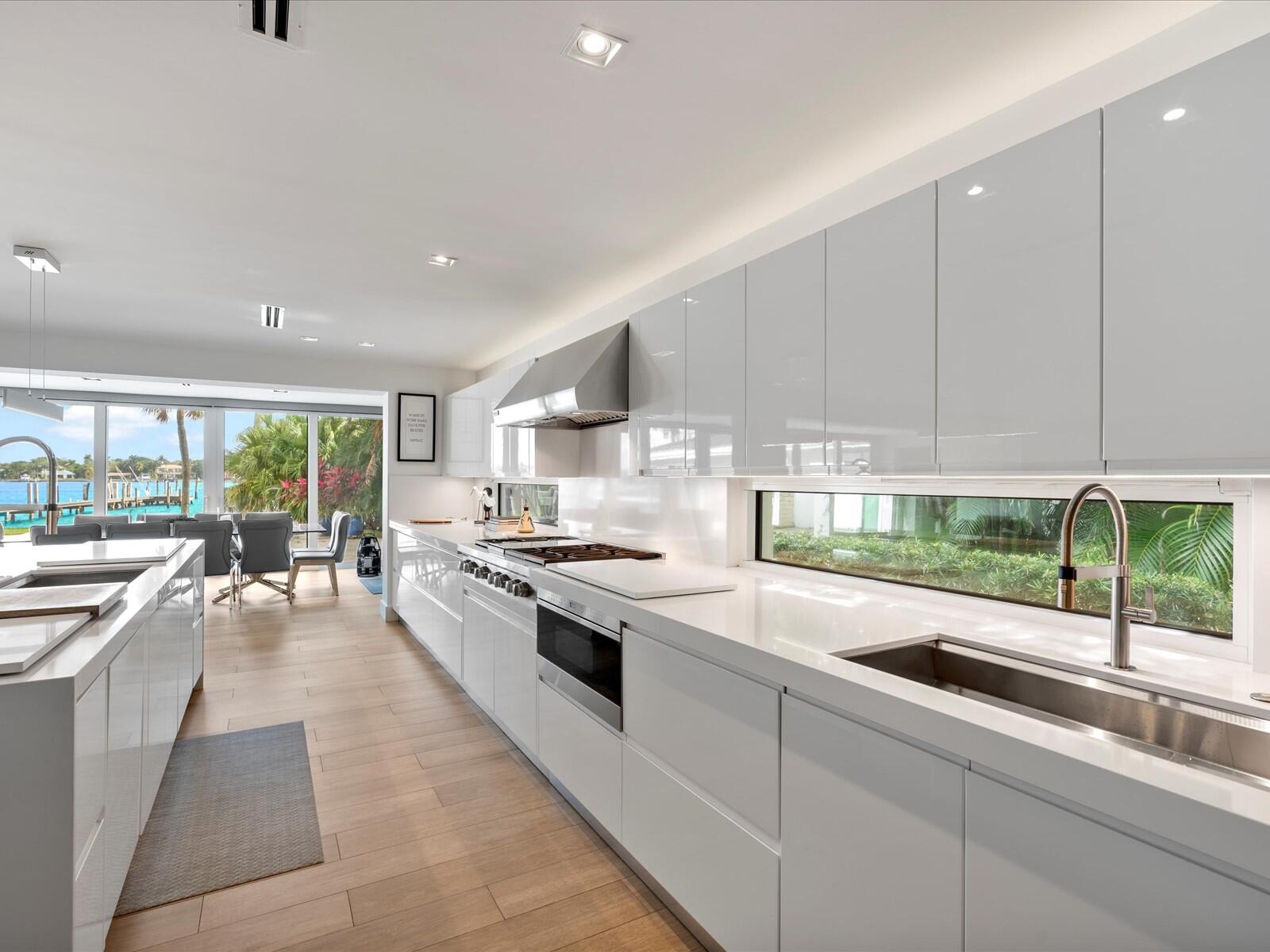 714 South Lake Drive Lantana, FL 33462 - Photo 11 of 41 a kitchen with stainless steel appliances granite countertop a stove a sink and a refrigerator