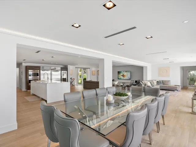 a living room with furniture wooden floor and a large window