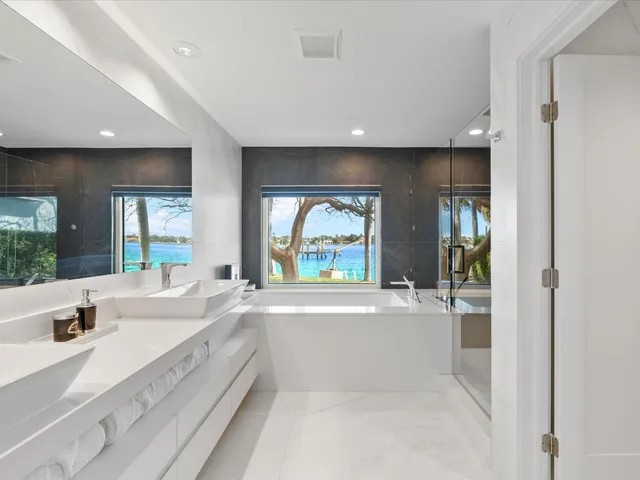 a large white kitchen with a large window