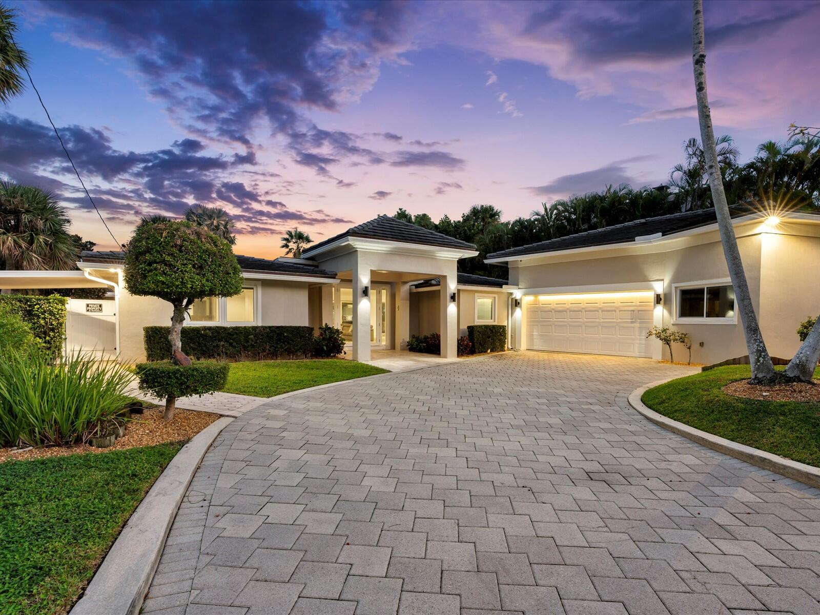 714 South Lake Drive Lantana, FL 33462 - Photo 2 of 41 a front view of a house with a yard and lake view