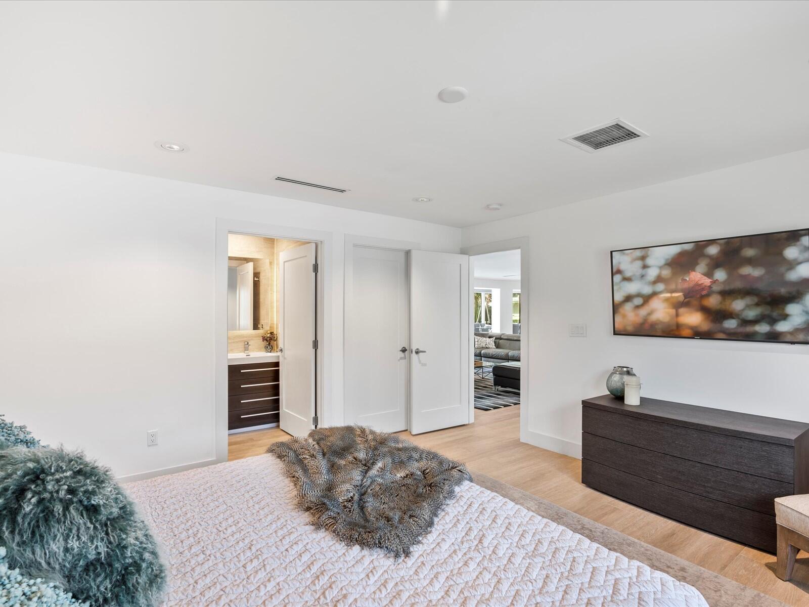 714 South Lake Drive Lantana, FL 33462 - Photo 22 of 41 a bedroom with a bed and a flat screen tv