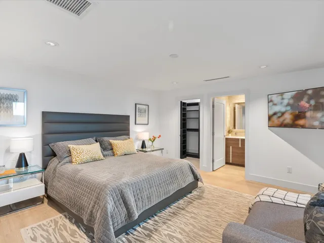 a bedroom with a large bed and a couch