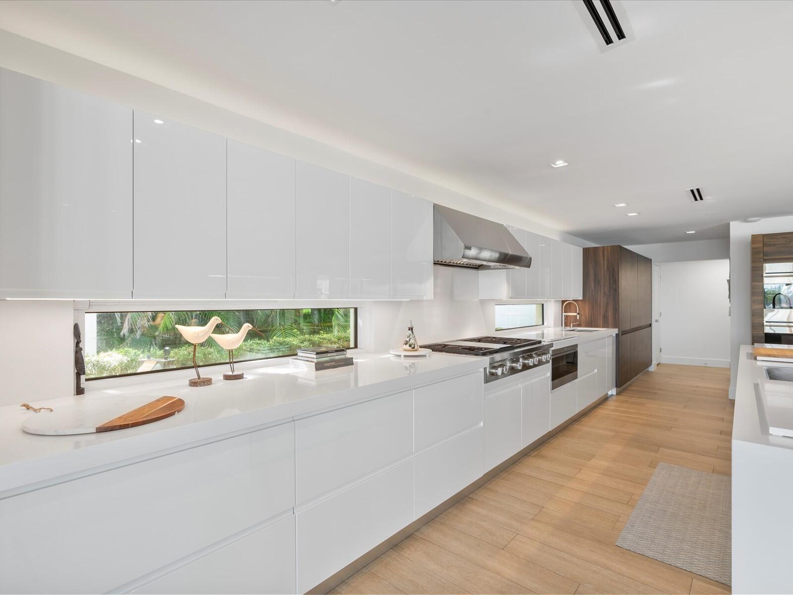 714 South Lake Drive Lantana, FL 33462 - Photo 9 of 41 a large white kitchen with stainless steel appliances granite countertop a stove and a sink