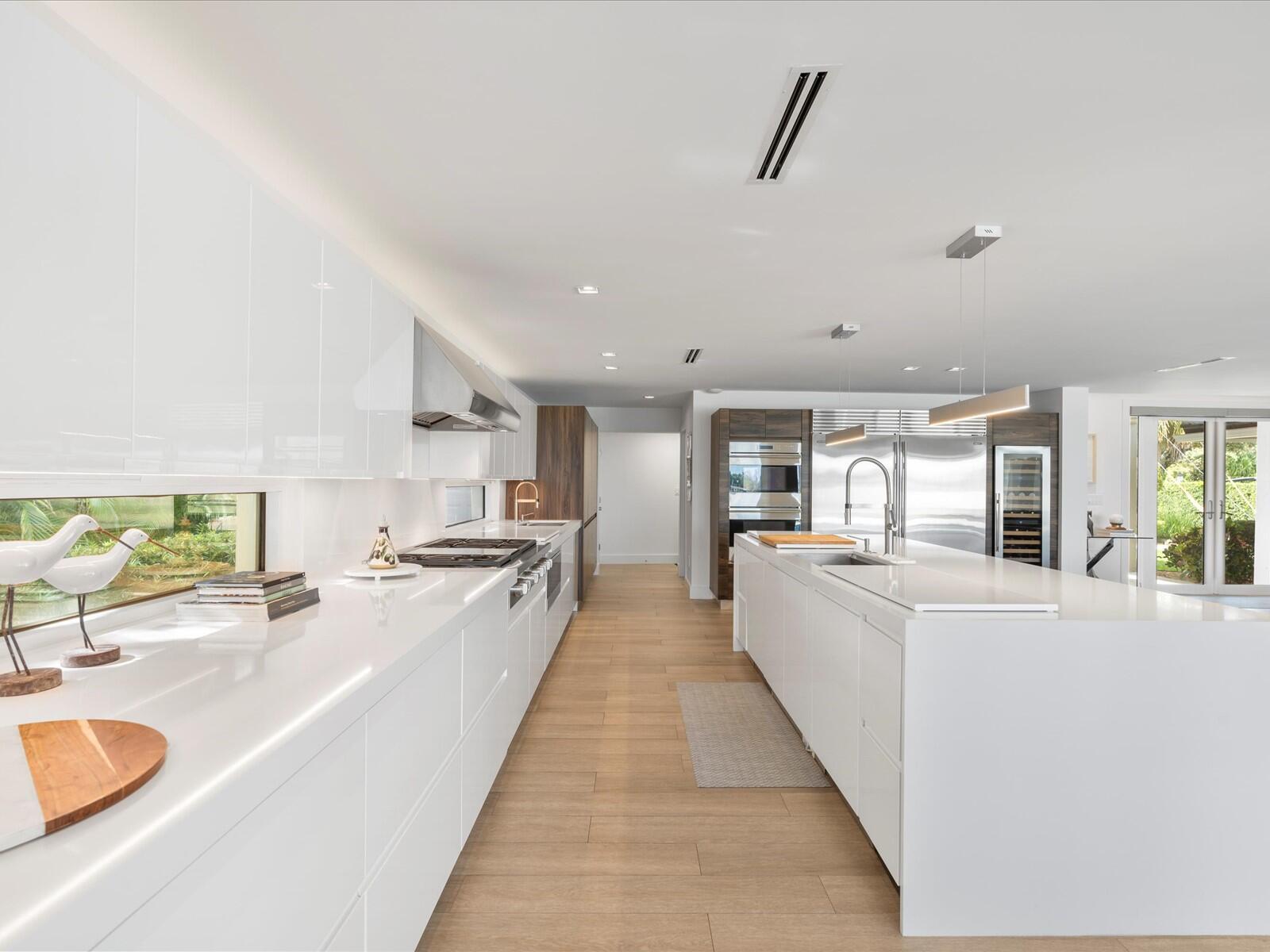 714 South Lake Drive Lantana, FL 33462 - Photo 10 of 41 a large white kitchen with granite countertop a large counter top and stainless steel appliances