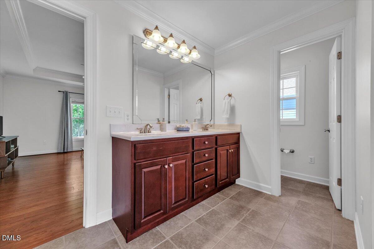 2908 Oak Bridge Drive Raleigh, NC 27610 - Photo 25 of 47 a spacious bathroom with a double vanity sink and a mirror